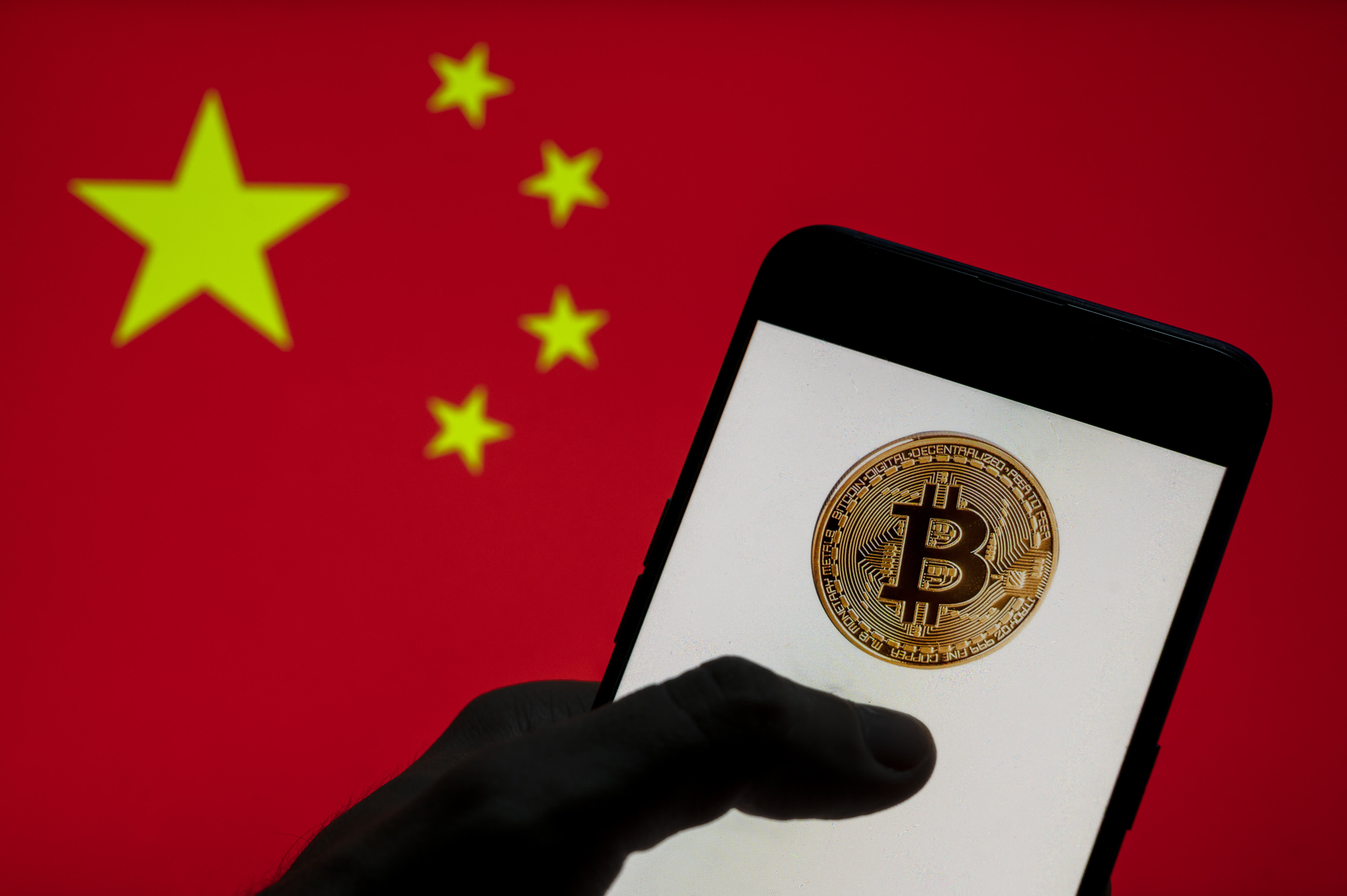 Bruised by stock market, Chinese rush into banned bitcoin | Reuters