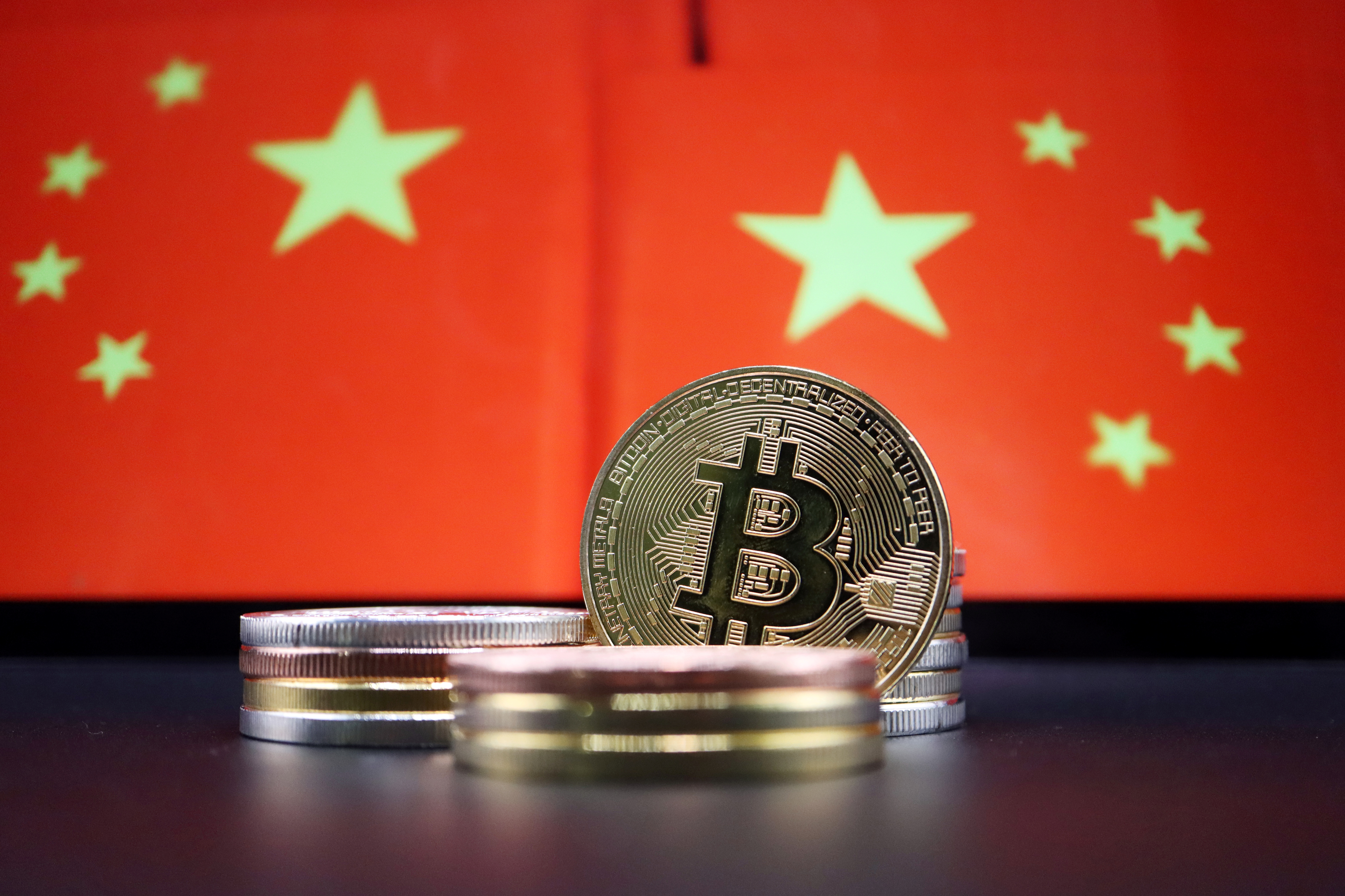 Bruised by stock market, Chinese rush into banned bitcoin | Reuters